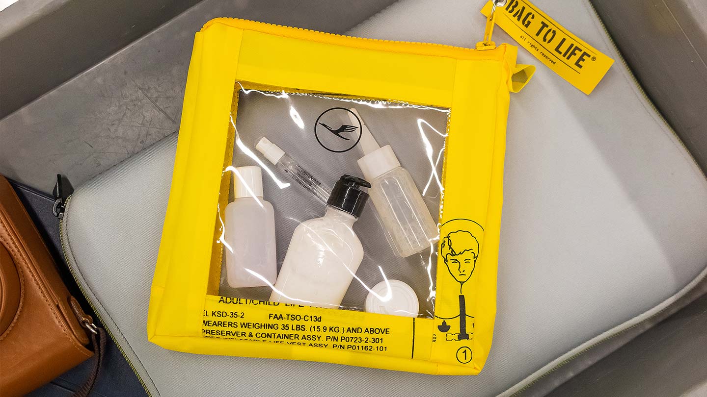 Cosmetic containers in transparent pouch made from airplane life vest, gift for travelers